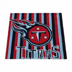 Tennessee Titans tufted rug on a white background: navy and light blue stripes with the flaming T crest and TITANS lettering.