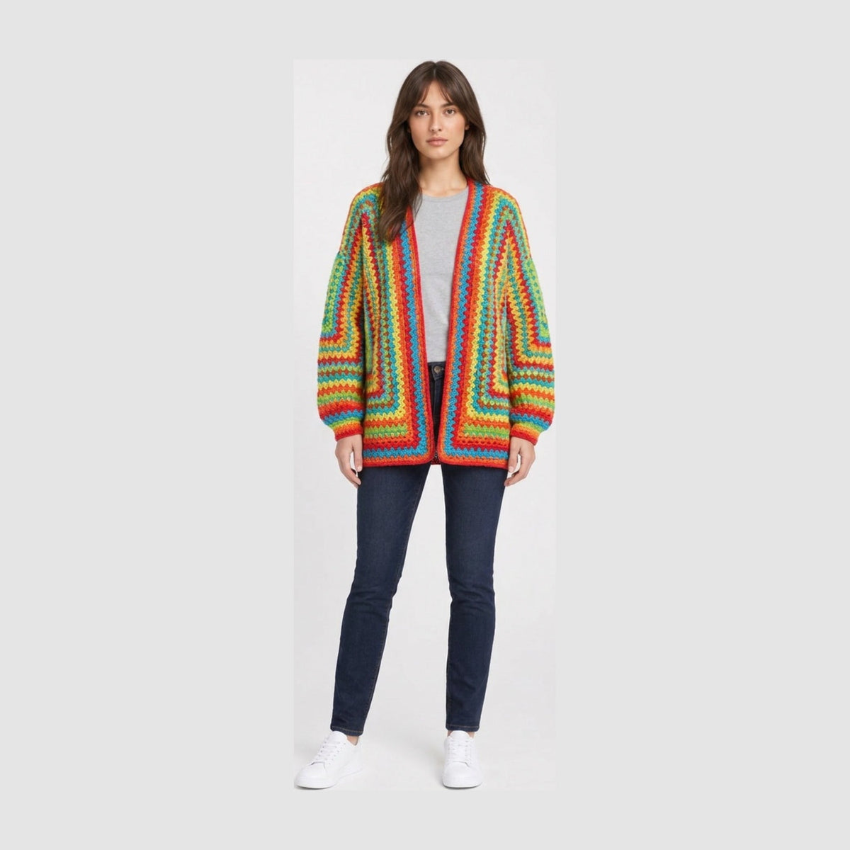 Open-front crochet cardigan in mitred rainbow stripes with red trim and balloon sleeves, worn over a grey tee.