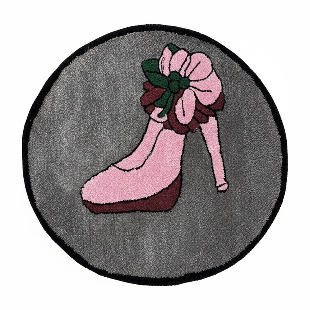 Retro pin-up tufted rug on a white background: round grey rug with a leg in a pink high heel and a pink rose at the ankle, bound in black.