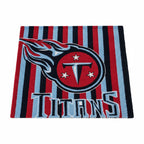 Tennessee Titans tufted rug on a white background: navy and light blue stripes with the flaming T crest and TITANS lettering.